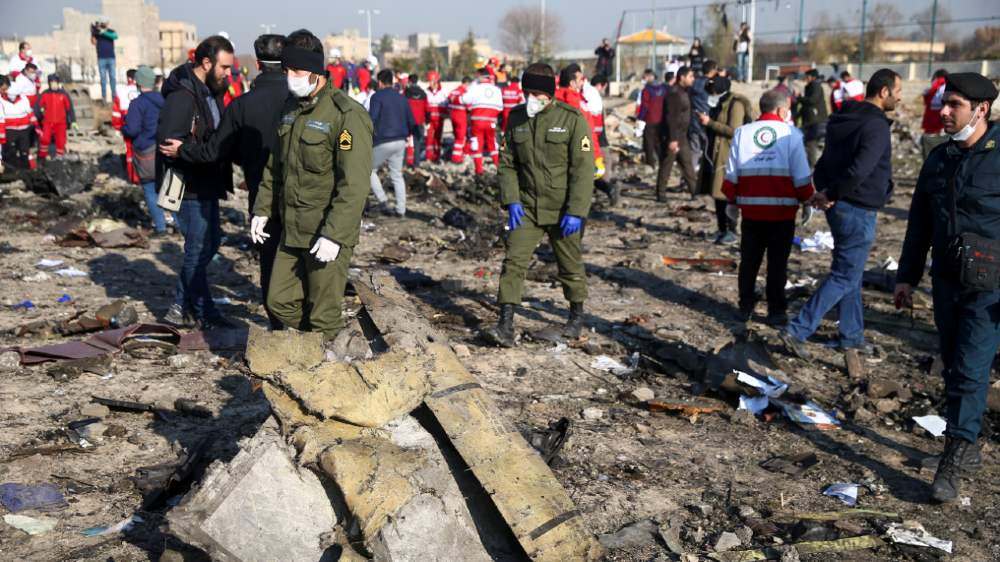 Security officers and Red Crescent workers at the crash site of the Ukrainian passenger plane on the outskirts of Tehran last week