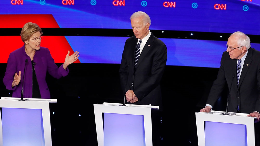 Democratic 2020 United States presidential candidate Senator Elizabeth Warren speaks as former Vice President Joe Biden and Senator Bernie Sanders listen during the seventh Democratic 2020 presidential debate at Drake University in Des Moines, Iowa