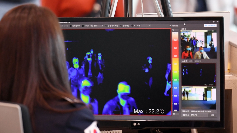 South Korean quarantine officials use thermal cameras to measure the temperatures of passengers from China at Incheon International Airport