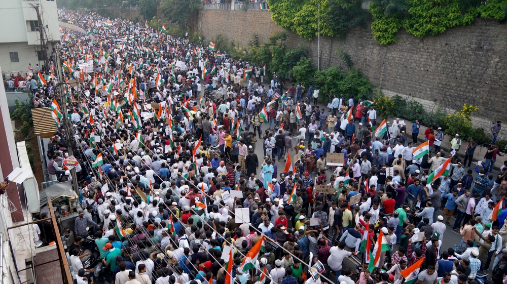 Demonstrators hold placards and flags as they attend a protest rally against a new citizenship law, in Hyderabad