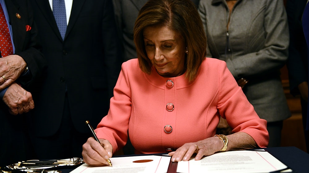 US Speaker of the House Nancy Pelosi signs the Articles of Impeachment against US President Donald Trump