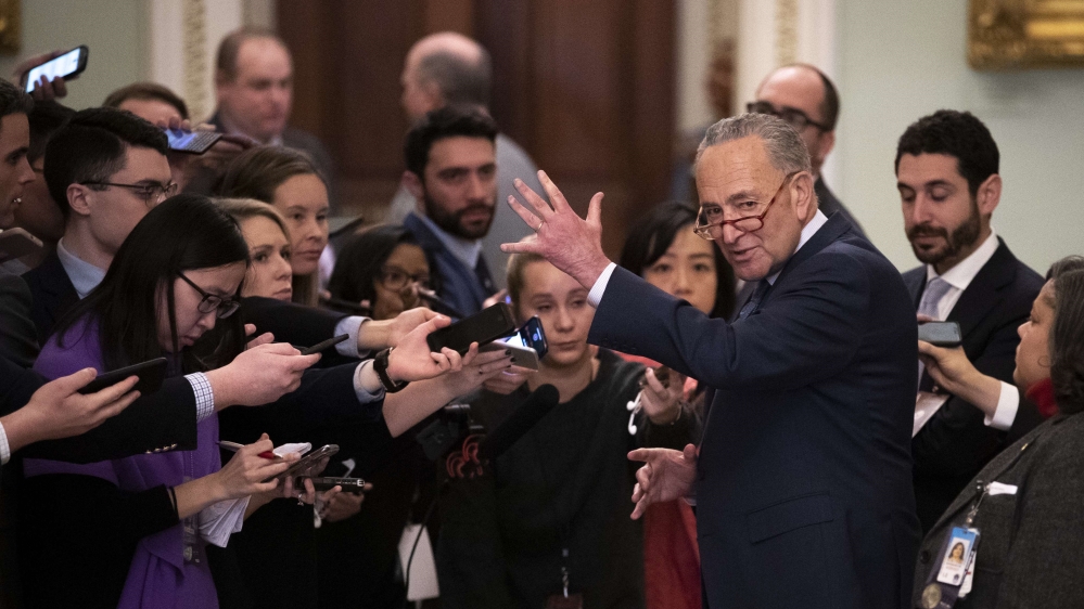Senate Minority Leader Chuck Schumer speaks to reporters outside of the Senate chamber during a short recess in the impeachment trial proceedings at the US Capitol