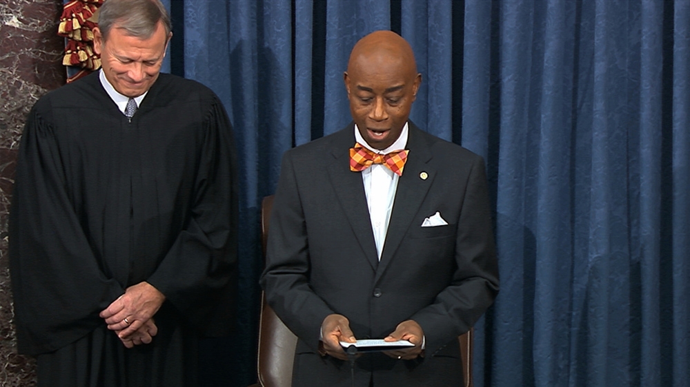 Chief Justice of the United States John Roberts smiles as Senate chaplain retired Navy Admiral Barry Black wishes him a happy birthday during the opening prayer of the impeachment trial against President Donald Trump. [The Associated Press]