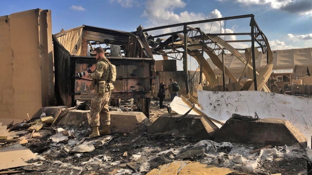 US soldiers and journalists inspect the rubble at a site of Iranian bombing, in Ain al-Assad airbase, Anbar, Iraq