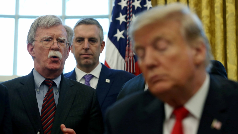 Trump listens as his then-NSA John Bolton speaks