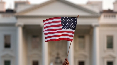A United States flag waving outside the White House, in Washington