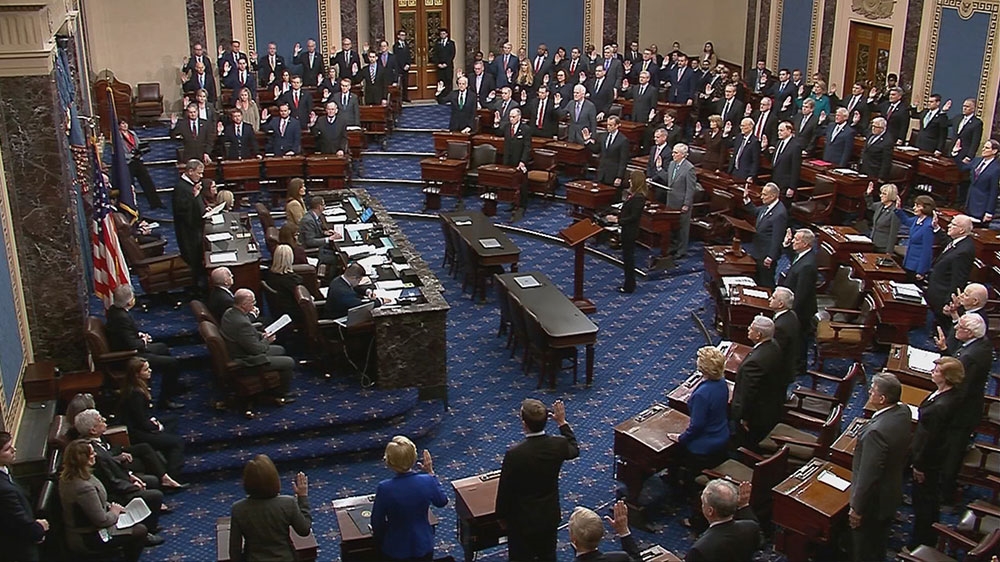 Chief Justice of the United States John Roberts swears in senators during the procedural start of the Senate impeachment trial of US President Donald Trump in this frame grab from video shot in the Senate Chamber at the US Capitol