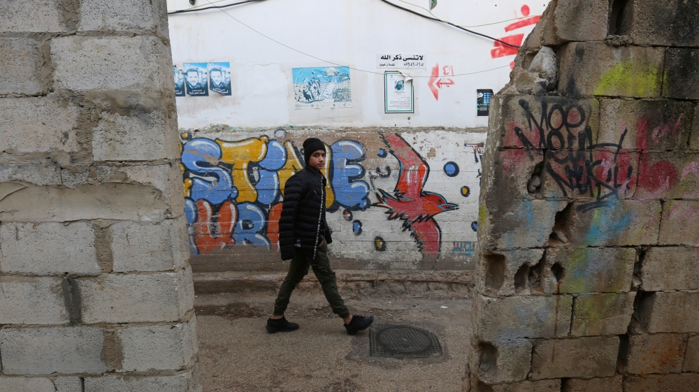 A boy walks along a street at Burj al-Barajneh refugee camp in Beirut, Lebanon