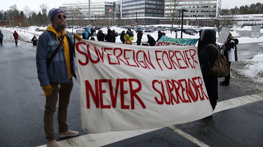 Supporters of the Wet’suwet’en nation, who oppose the construction of the Coastal GasLink pipeline, protest outside the provincial headquarters of the RCMP in Surrey, BC