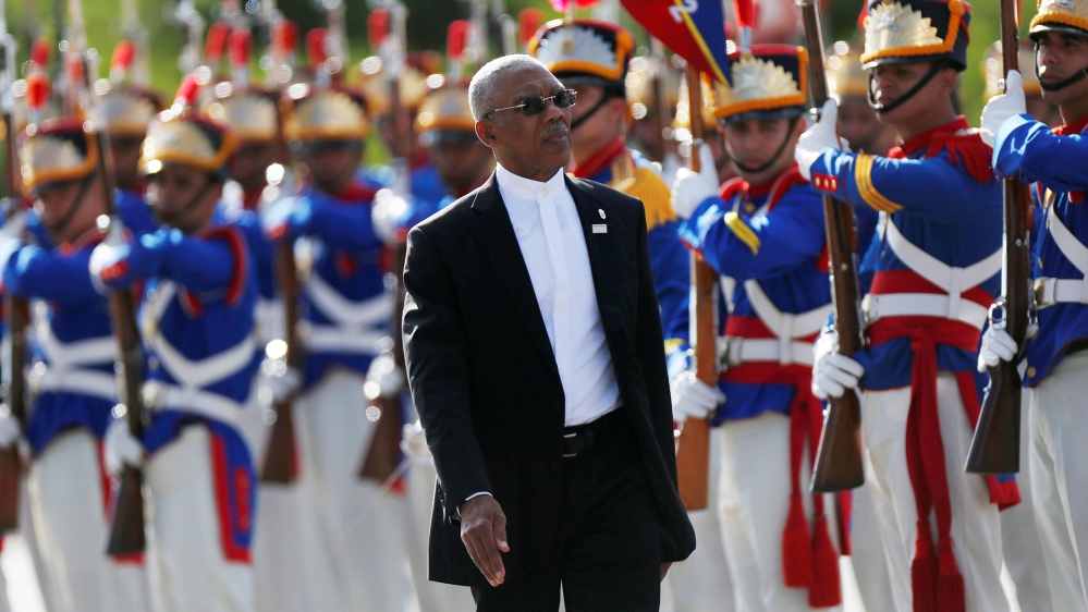 Guyana’s President David Granger reviews an honour guard during a Mercosur trade bloc annual summit in Brasilia in December 2017
