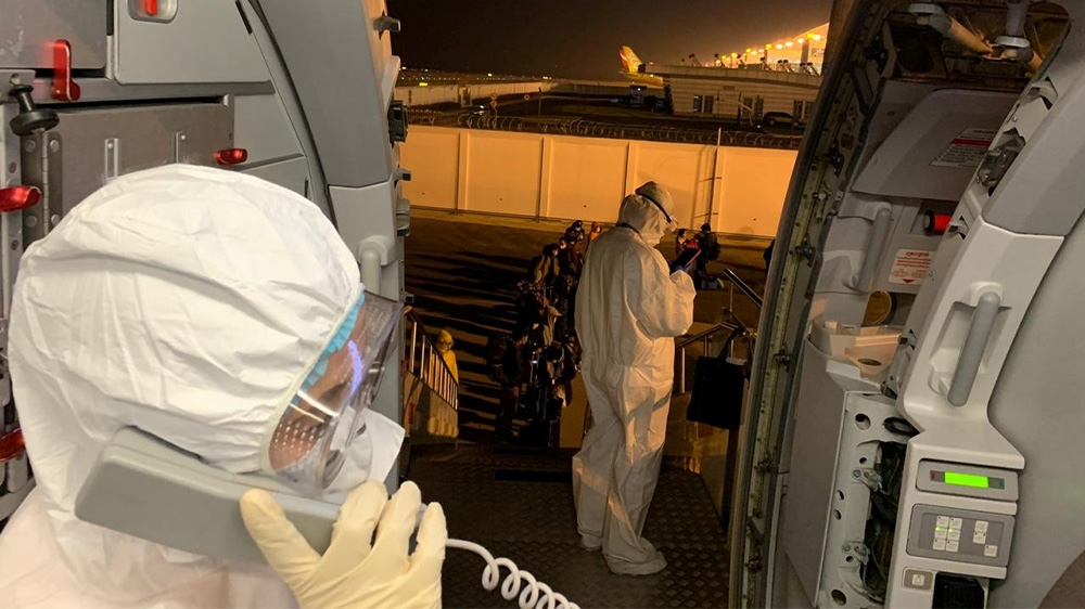 Filipinos board a chartered plane from Wuhan to return home [Department of Foreign Affairs via Reuters]