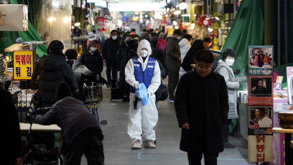 An employee from a disinfection service company sanitizes the floor of a traditional market in Seoul, South Korea [Reuters]