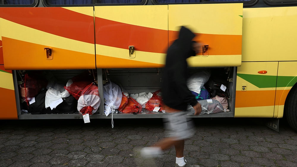 People deported from the United States get off a bus at an immigration facility in San Salvador, El Salvador
