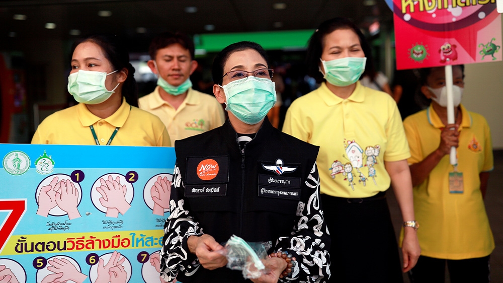 Officials in Bangkok give out masks free of charge as a preventive measure against the coronavirus