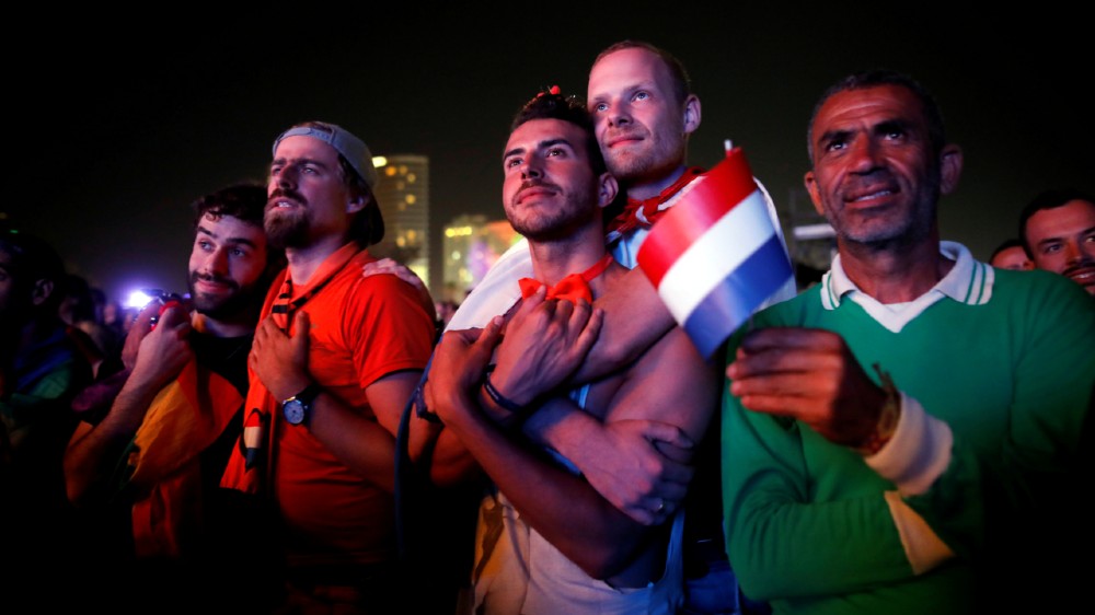 Fans watch on a big screen the 2019 Eurovision song contest final in the fans zone by the beach in Tel Aviv, Israel
