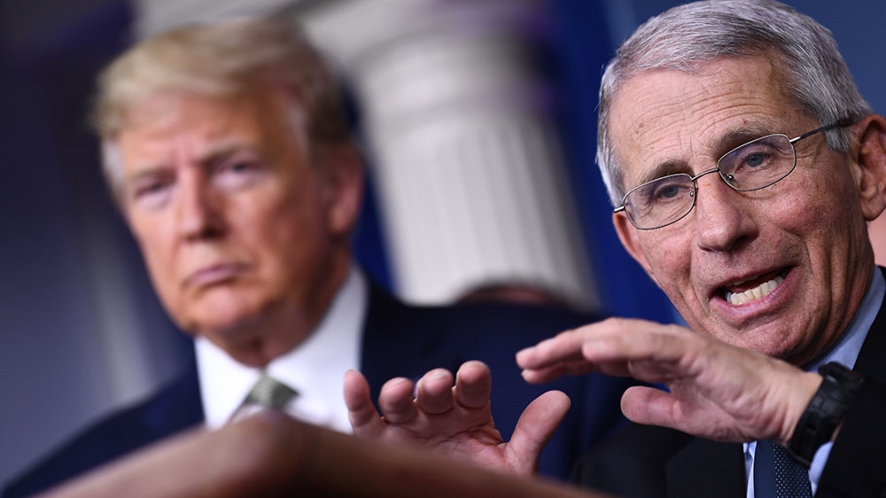 Dr Anthony Fauci speaks as US President Donald Trump listens during the daily press briefing on the Coronavirus pandemic situation at the White House