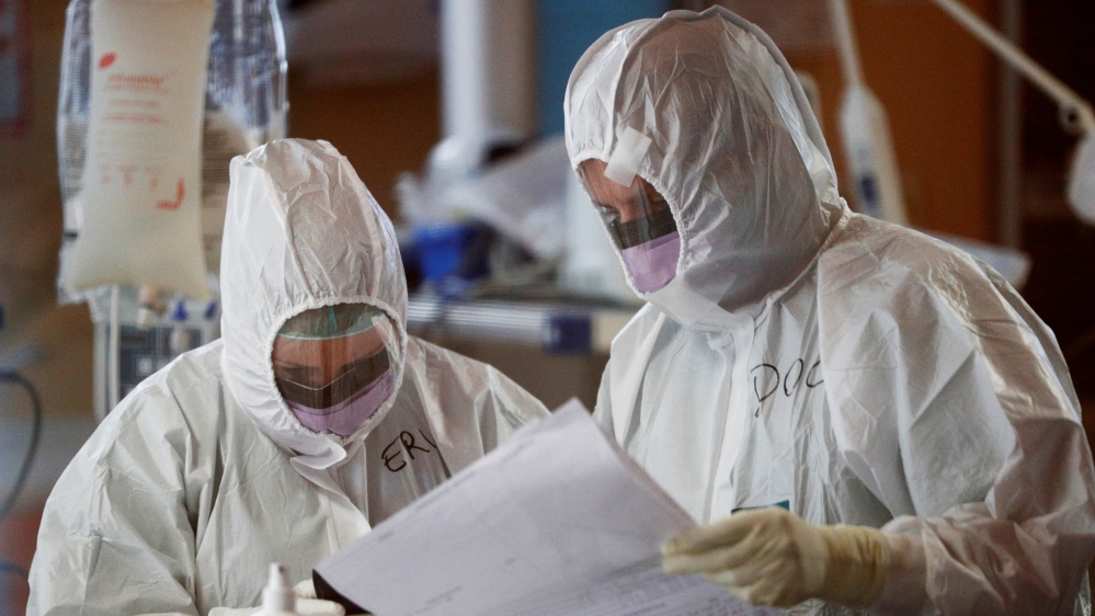 Medical workers in protective suits treat patients suffering with coronavirus disease (COVID-19) in Rome