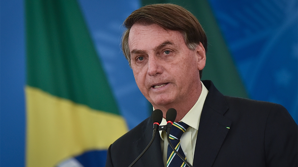President Jair Bolsonaro speaks to journalists about the coronavirus pandemic at the Planalto Presidential Palace in Brasilia