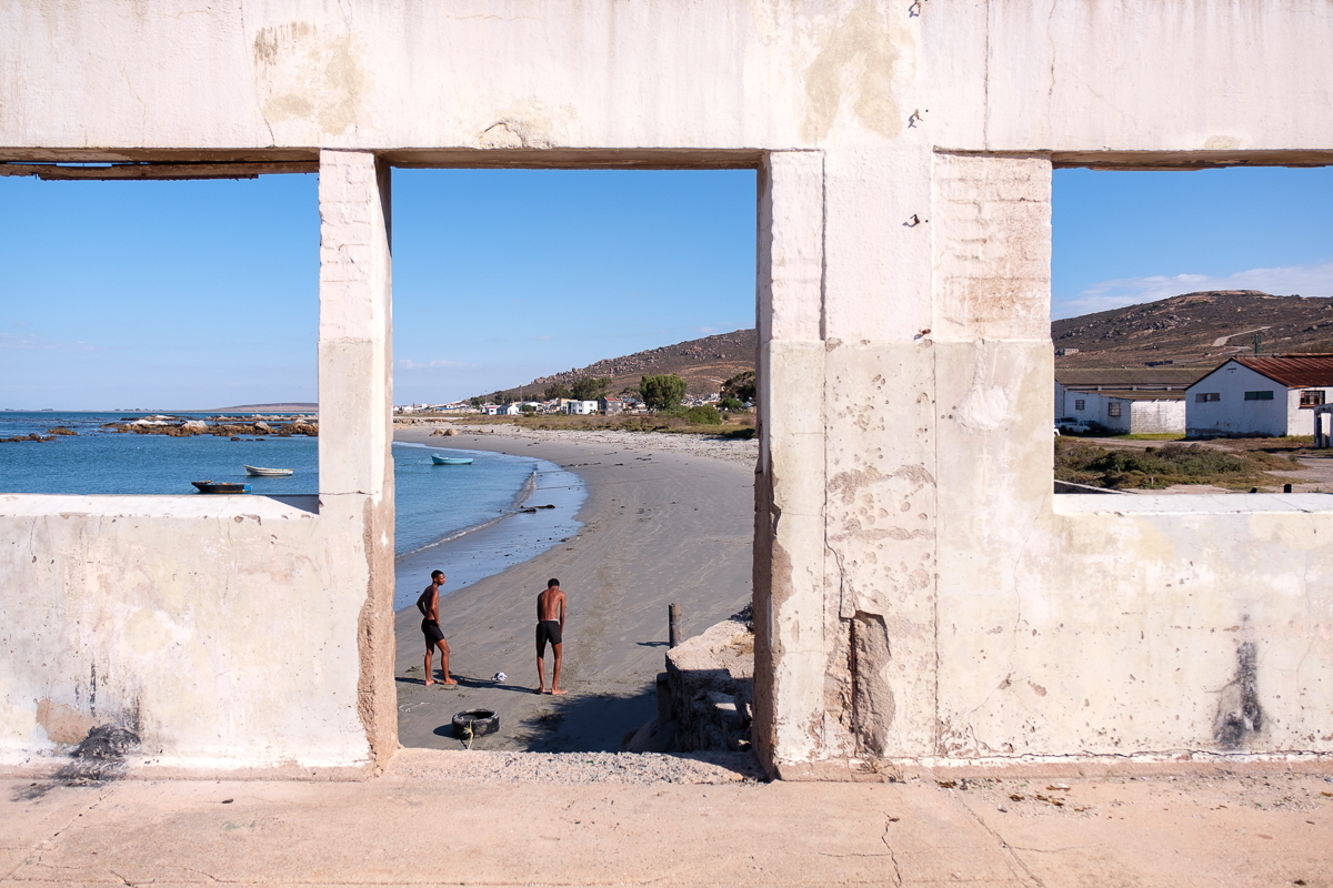 Two high school sprinters train for athletics on the beach outside the abandoned fish factory. Barring a football field, there are no recreational facilities available to young people. In the past so