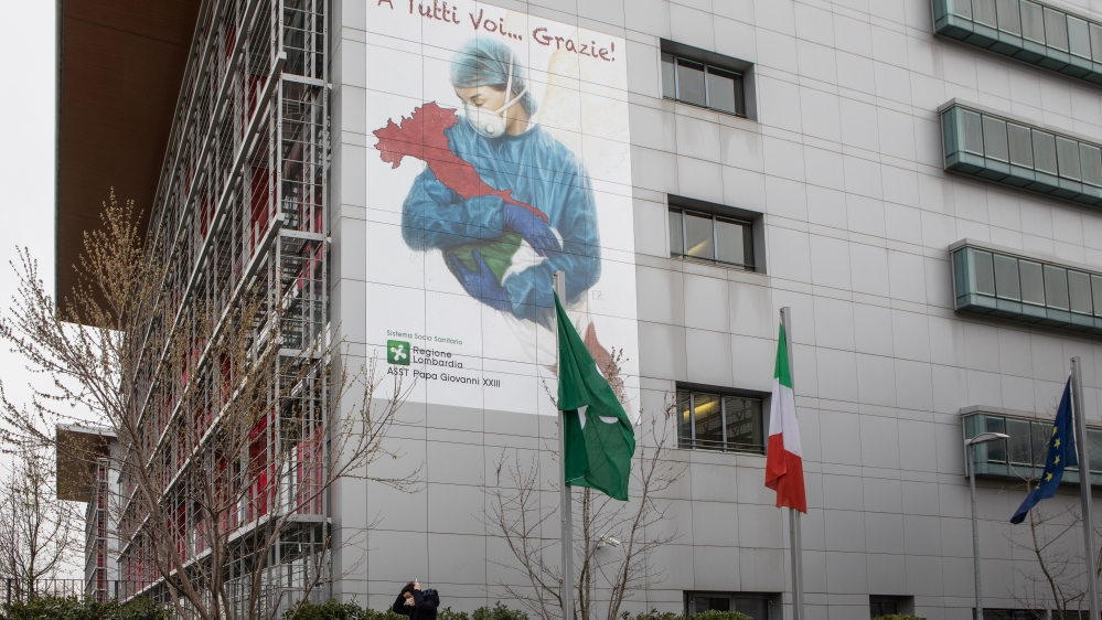 This picture shows a mural dedicated to all Italian medical workers depicting a nurse cradling Italy and reading ‘To All Of You … Thank You!’, on a wall of Papa Giovanni XXIII Hospital in Bergamo, near Milan, Italy