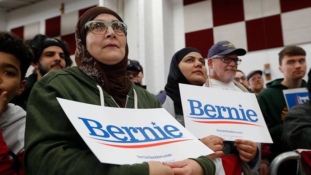 Supporters of Democratic presidential candidate Bernie Sanders listen to him speak during a campaign rally in Dearborn, Michigan.
