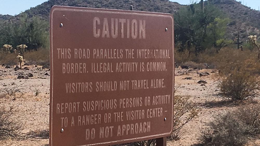A sign warns visitors of possible danger in Organ Pipe Cactus National Monument in Arizona