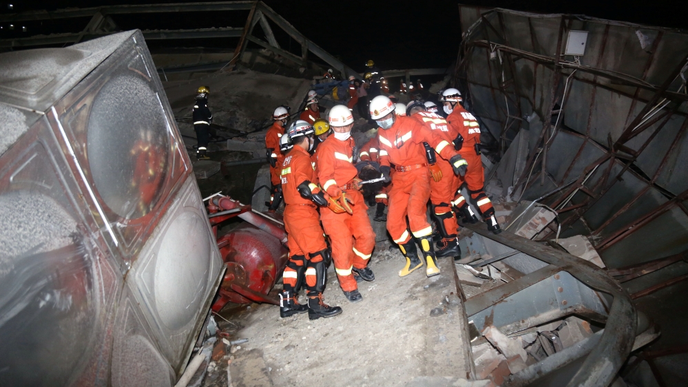 Rescue workers move casualty on the site where a hot