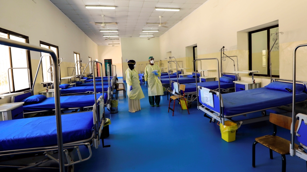 A Somali doctor and a nurse wear protective face masks as they prepare a ward for coronavirus disease (COVID-19) patients, at the Martini Hospital in Mogadishu