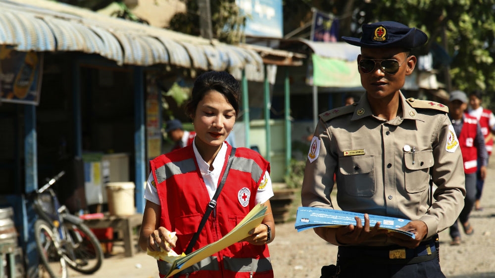 Members of the Myanmar Red Cross Society distributing information about COVID-19 in the western town of Rakhine