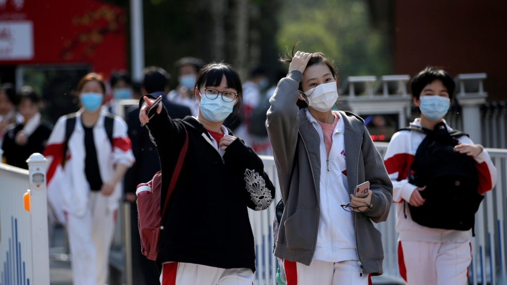 Students wearing face masks leave a school in Beijing as senior high school students in the Chinese capital returned to campus on April 27, 2020