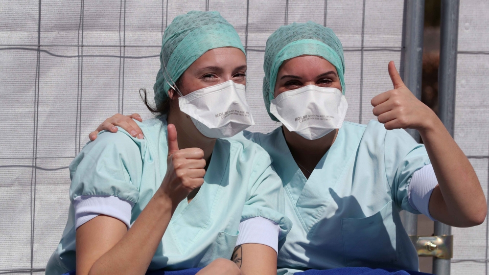 Members of the medical personnel gesture in the testing site for coronavirus disease at CHU de Liege hospital in Liege, Belgium