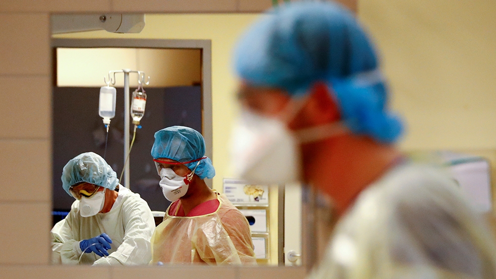 Medical staff in protective suits treat a patient suffering from the coronavirus disease (COVID-19) in an intensive care unit at Havelhohe community hospital in Berlin