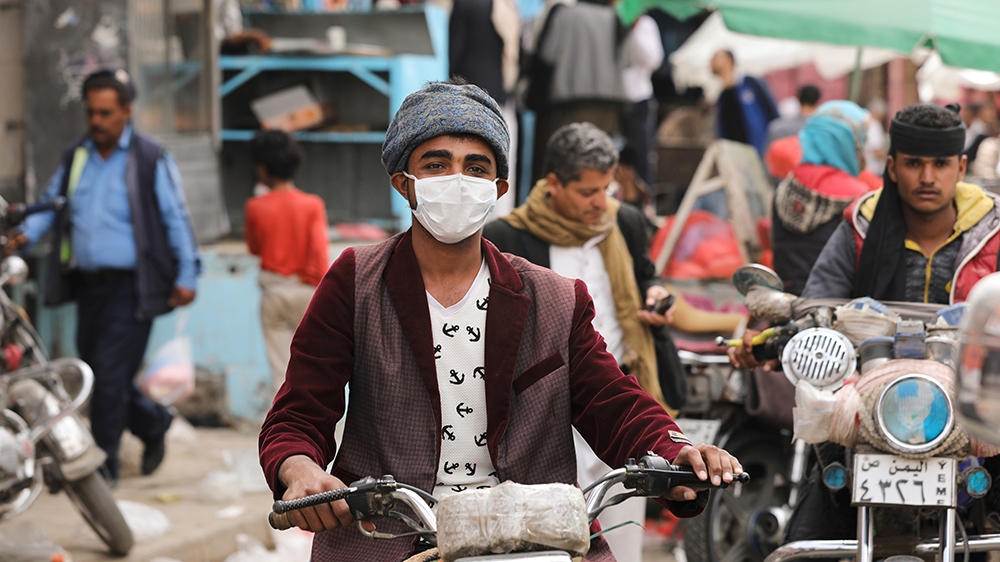 A man wears a protective face mask as he rides a motorcycle amid fears of the spread of the coronavirus disease (COVID-19) in Sanaa, Yemen March 16, 2020. Picture taken March 16, 2020. REUTERS/Khaled Abdullah