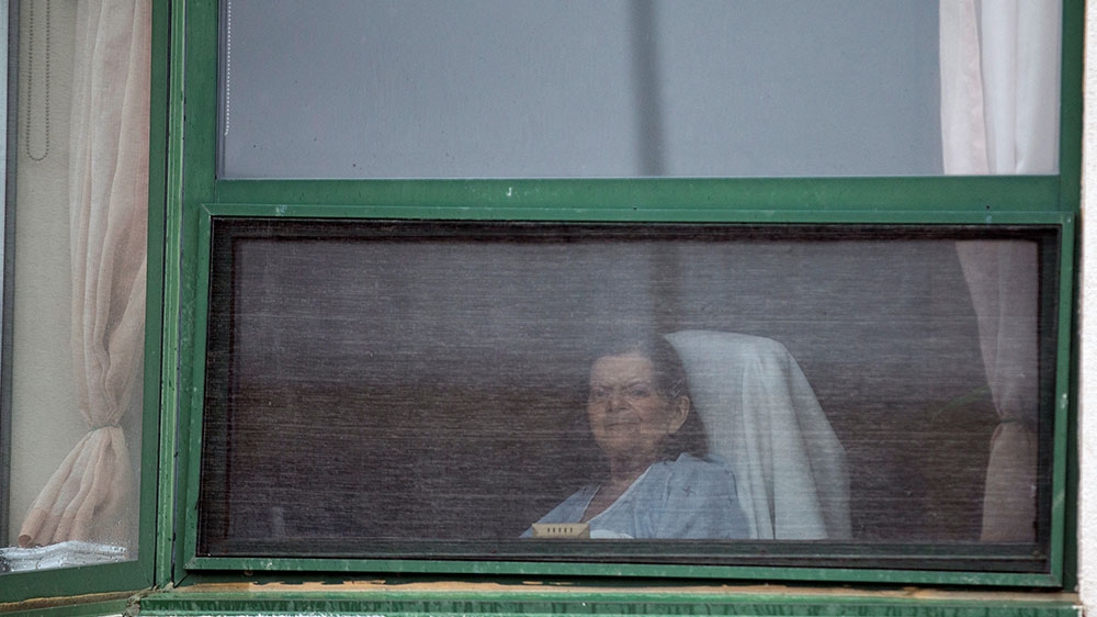 A resident at her window at Residence Herron in Montreal