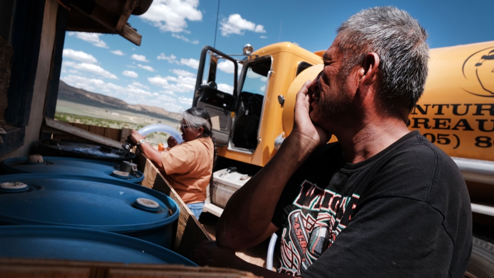 A member of the Navajo Nation, receives his monthly water delivery in the town of Thoreau