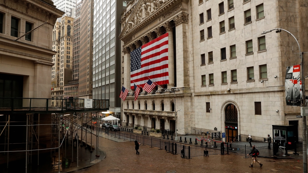 US flags fly outside of the New York Stock Exchange as markets continue to react to the coronavirus disease