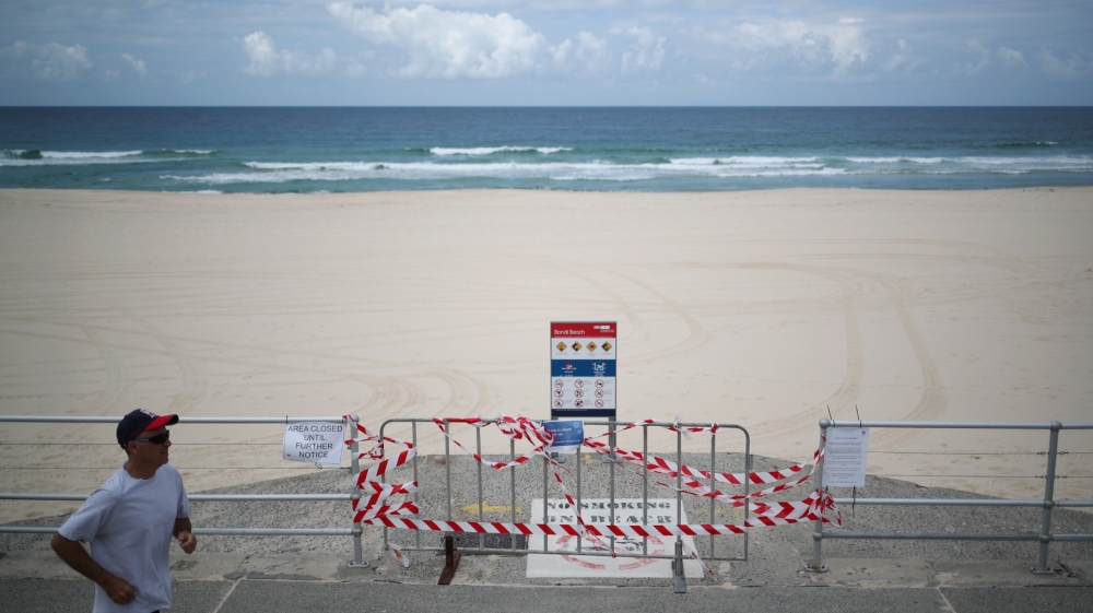 A jogger runs past a cordoned-off entrance to Bondi Beach in Sydney on April 1