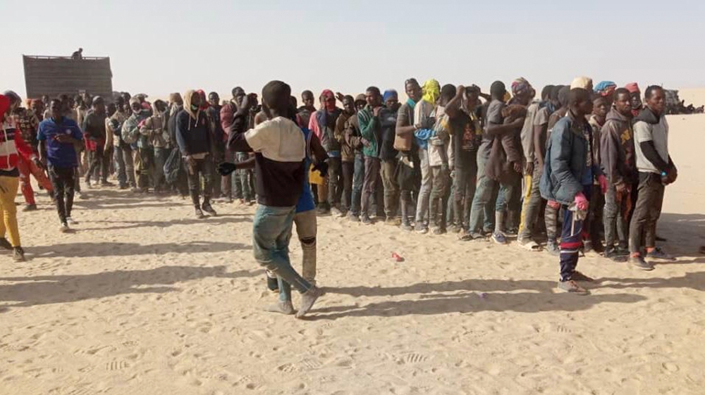 Migrants receiving assistance in Madama, a military outpost close to the border between Niger and Libya
