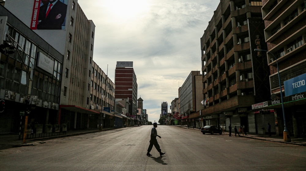 A policeman crosses an empty street during a 21-day nationwide lockdown aimed for limiting the spread of the coronavirus disease (COVID-19) in Harare, Zimbabwe, April 12, 2020. REUTERS/Philimon Bulawa