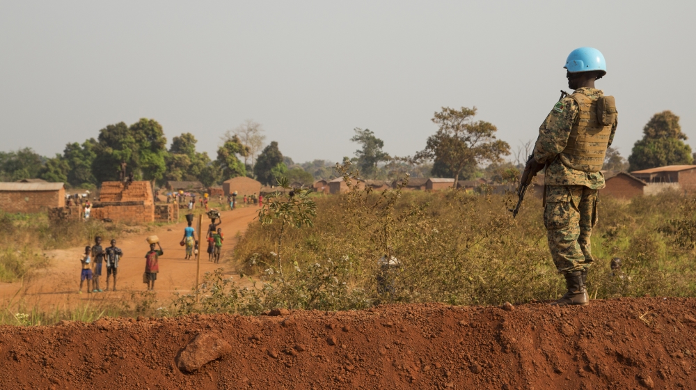 A ‘blue helmet’ soldier guards the outer perimeter of UN peacekeeping base in the town of Bria