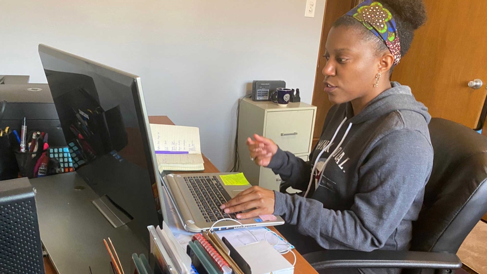A middle school reading teacher conducting an online lesson from her home office in Chicago, Illinois, US.