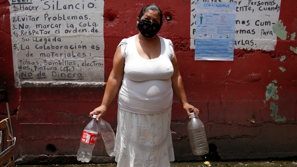 Venezuela /woman waits for her turn to fills plastic bottle