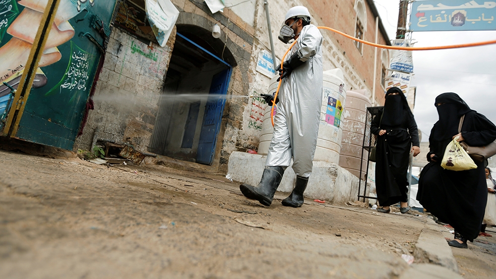 A health worker wearing a protective suit disinfects a market amid concerns of the spread of the coronavirus disease (COVID-19), in Sanaa, Yemen April 28, 2020. REUTERS/Khaled Abdullah