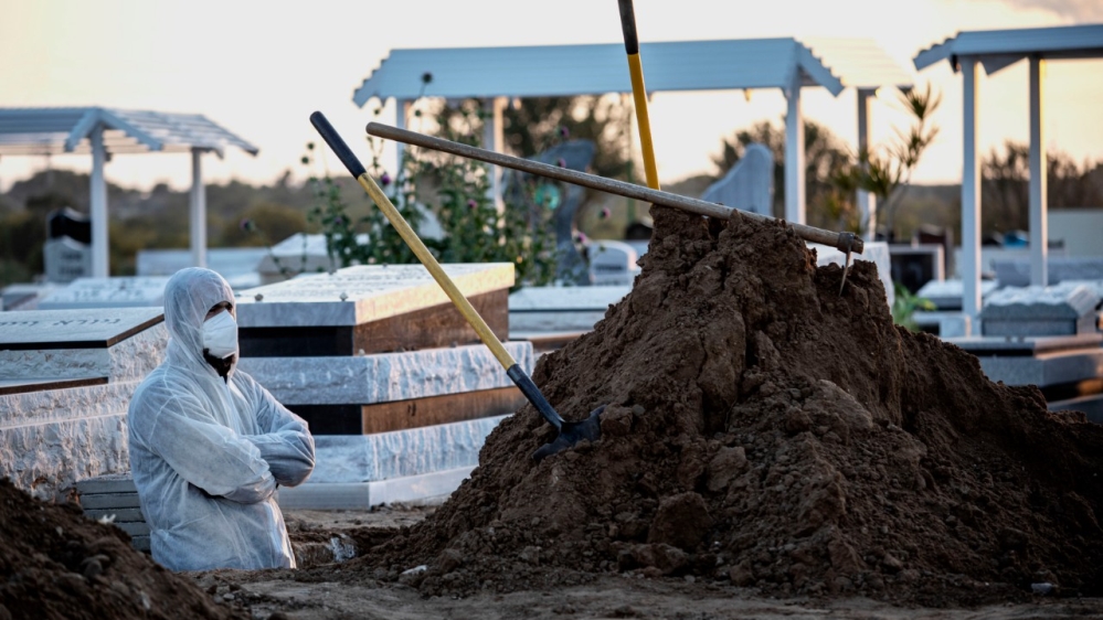A member of Hevra Kadisha, an organisation which prepares the bodies of deceased Jews for burial according to Jewish traditions, digs a grave in the coastal city of Ashkelon, Israel.