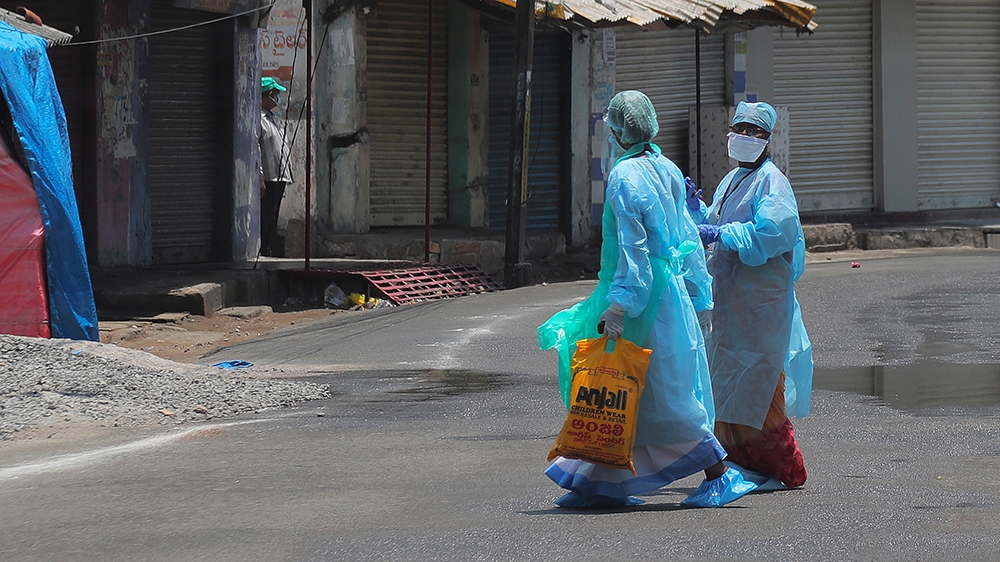 Indian Health worker walks inside a containment zone during lockdown to prevent the spread of new coronavirus in Hyderabad, India, in Hyderabad, India, Sunday, April 26, 2020. A tentative easing around the world of coronavirus lockdowns gathered pace Saturday with the reopening in India of neighborhood stores that many of the country’s 1.3 billion people rely on for everything from cold drinks to mobile phone data cards. (AP Photo/Mahesh Kumar A.) [The Associated Press]