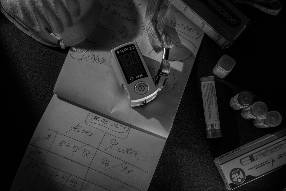 Medicines, oximeter, thermometer, the protective mask and other gears on their therapy notes. In this notebook, Marta and Alessio noted every single day symptoms and therapy to keep the record and tel