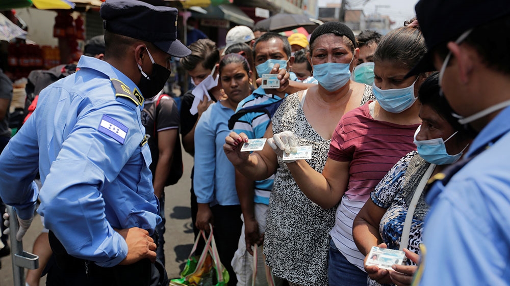 Police officers control access to a marketplace as part of restrictions aimed at halting the spread of the coronavirus disease (COVID-19), in Tegucigalpa, Honduras