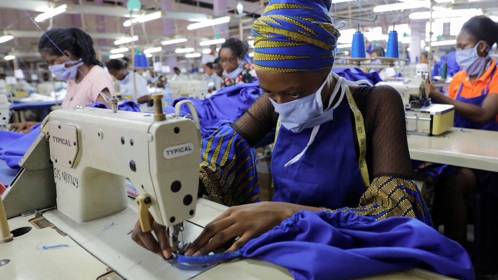 Workers of a local factory begin the production of personal protective gear for local frontline health workers in Accra