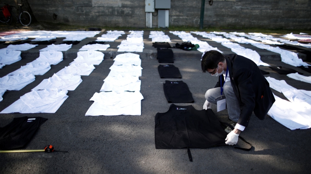Dozens of chef’s aprons, chef’s hats, and restaurant trays are displayed on the ground of a bank of the Seine river in Paris during a nationwide protest by restaurants and bars owners