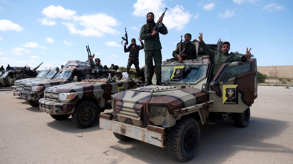 Libyan National Army (LNA) members, commanded by Khalifa Haftar, pose for a picture as they head out of Benghazi to reinforce the troops advancing to Tripoli, in Benghazi, Libya April 7, 2019. REUTERS